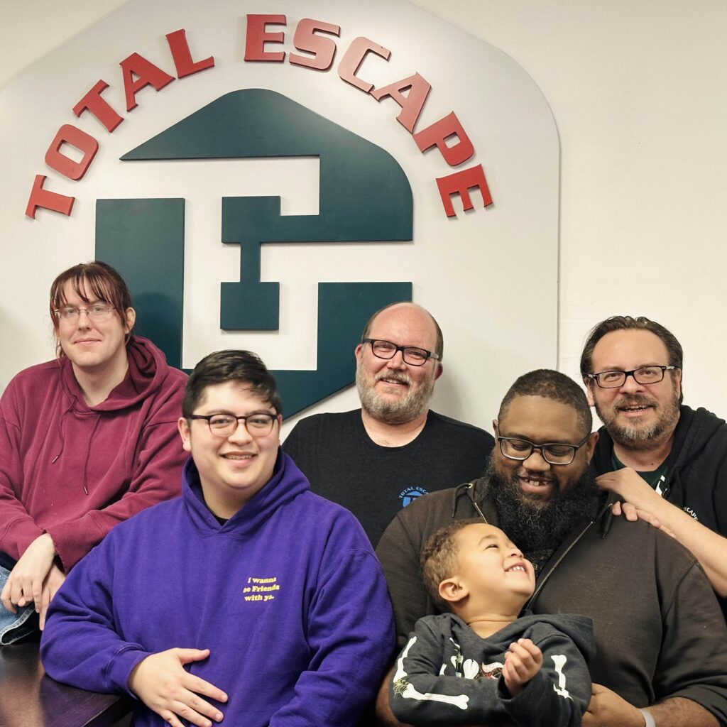 A group of our employees sitting together and smiling at the camera