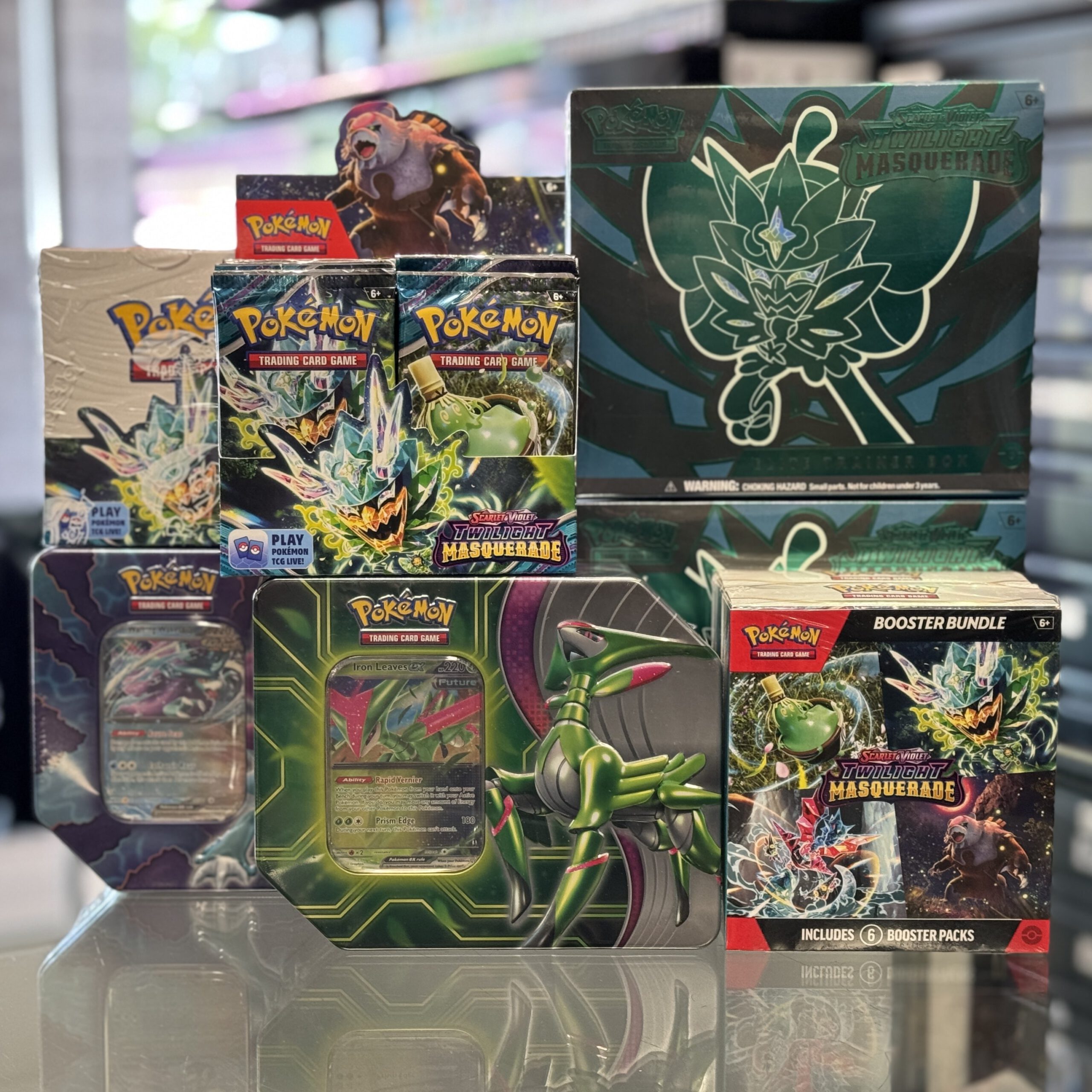 A variety of Pokémon sealed and box products on a counter